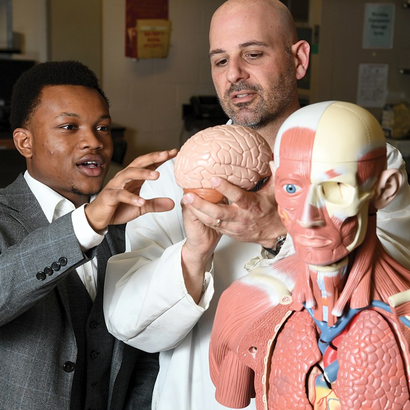 Prof. Andrews and Student Holding Brain