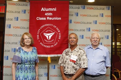 Alums posing with their 4th class reunion banner