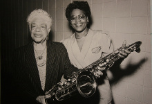 Photo of Ruth Sears presenting her husband's saxophone to York College president Josephine Davis