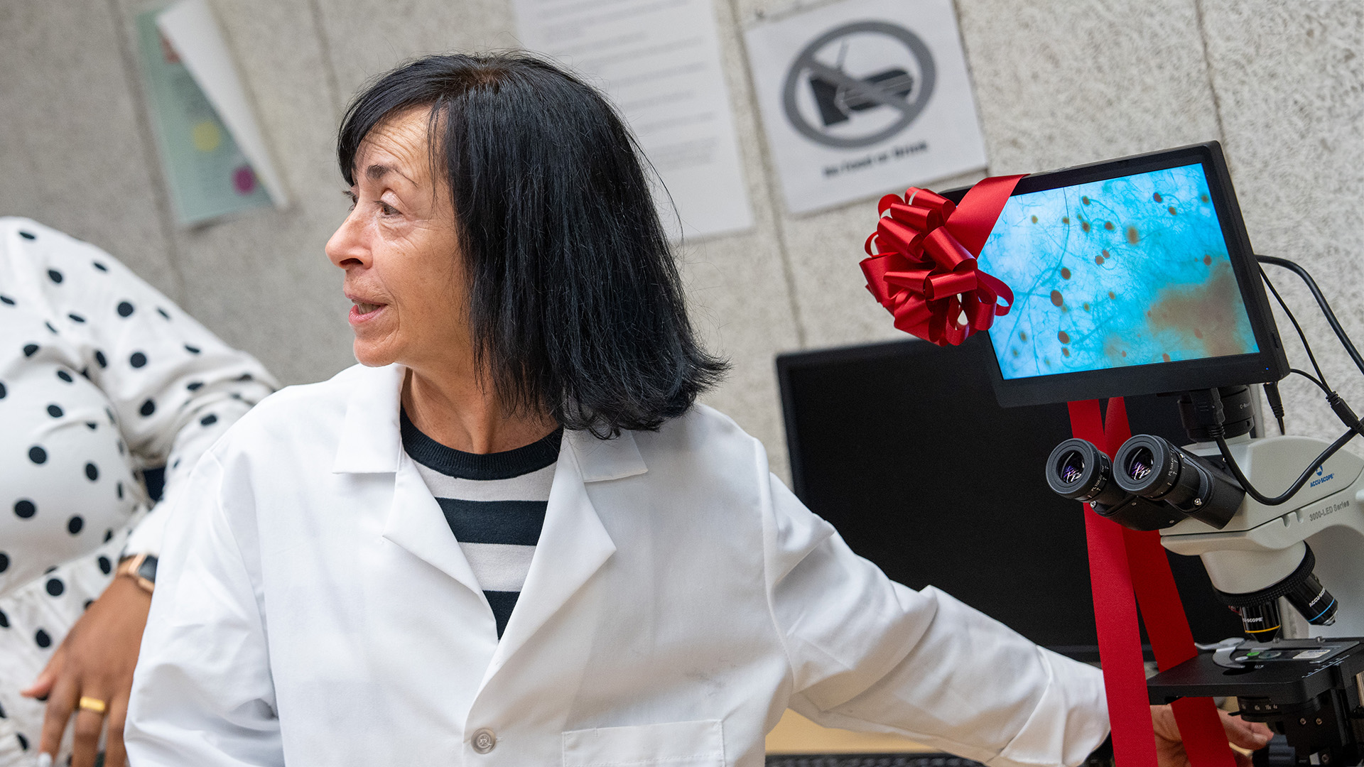 Faculty with ADA microscope