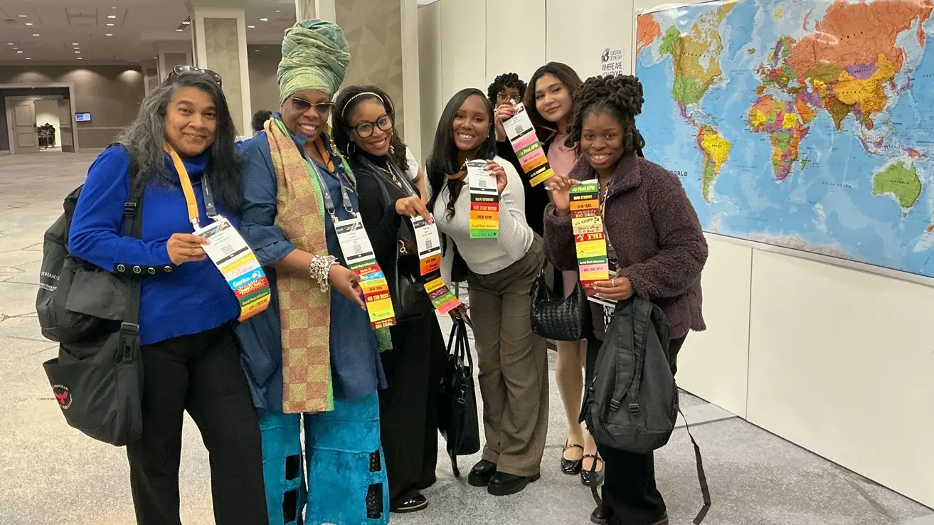 MSW faculty and student next to world map