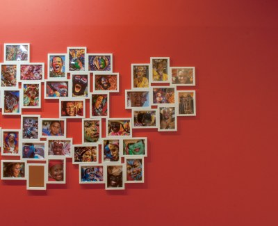 large number of small photographs as installed in a cluster in the gallery, right portion